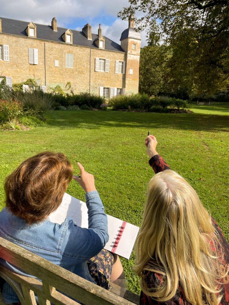 Learning how to draw a building in open air during urban sketching holiday in France